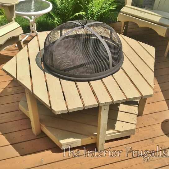 diy outdoor fireplace idea featuring round metal fire bowl and screen built into adirondack style hexagon shaped coffee table