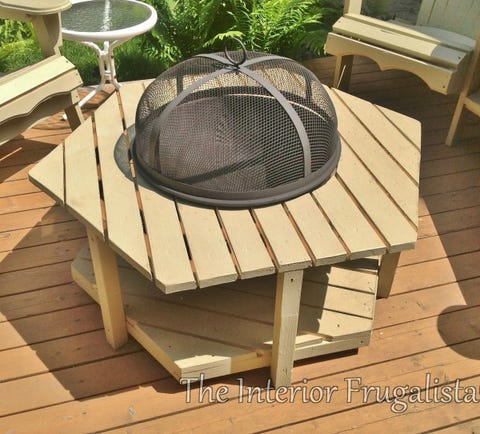 diy outdoor fireplace idea featuring round metal fire bowl and screen built into adirondack style hexagon shaped coffee table