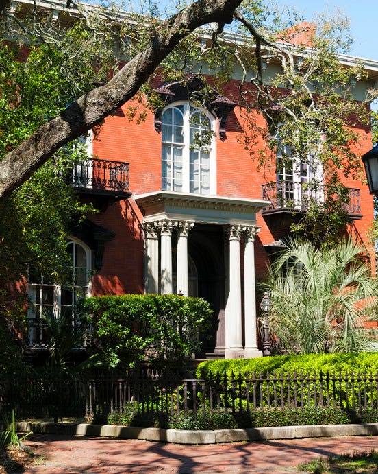 savannah, georgia, usa   march 5, 2009 historic mercer williams house as seen from one of the public squares designed in 1860, this italianate revival that inspired midnight in the garden of good and evil played host to three untimely
deaths and is supposedly built, like much of the city, on top of unmarked graves