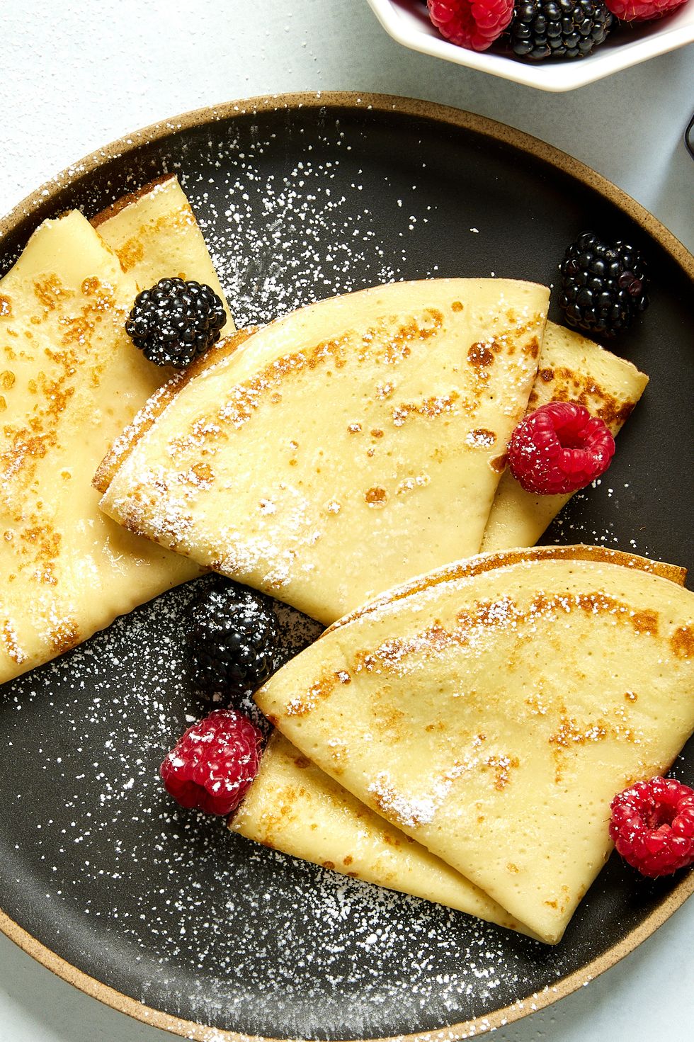 crepes with raspberries, blackberries, and dusted with powdered sugar