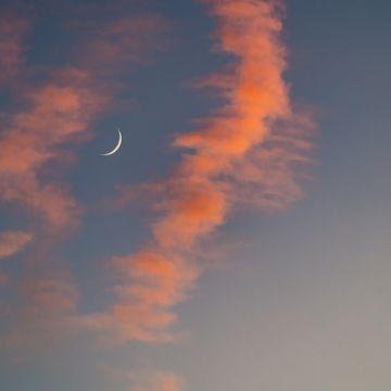 crescent moon during a sunset