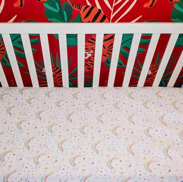 a baby crib with a colorful sheet