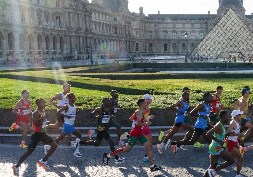 10 august 2024, france, paris olympics, paris 2024, athletics, marathon, men, the runners run past the louvre photo michael kappelerdpa photo by michael kappelerpicture alliance via getty images