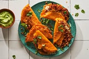 crispy chipotle chicken tacos on a teal plate