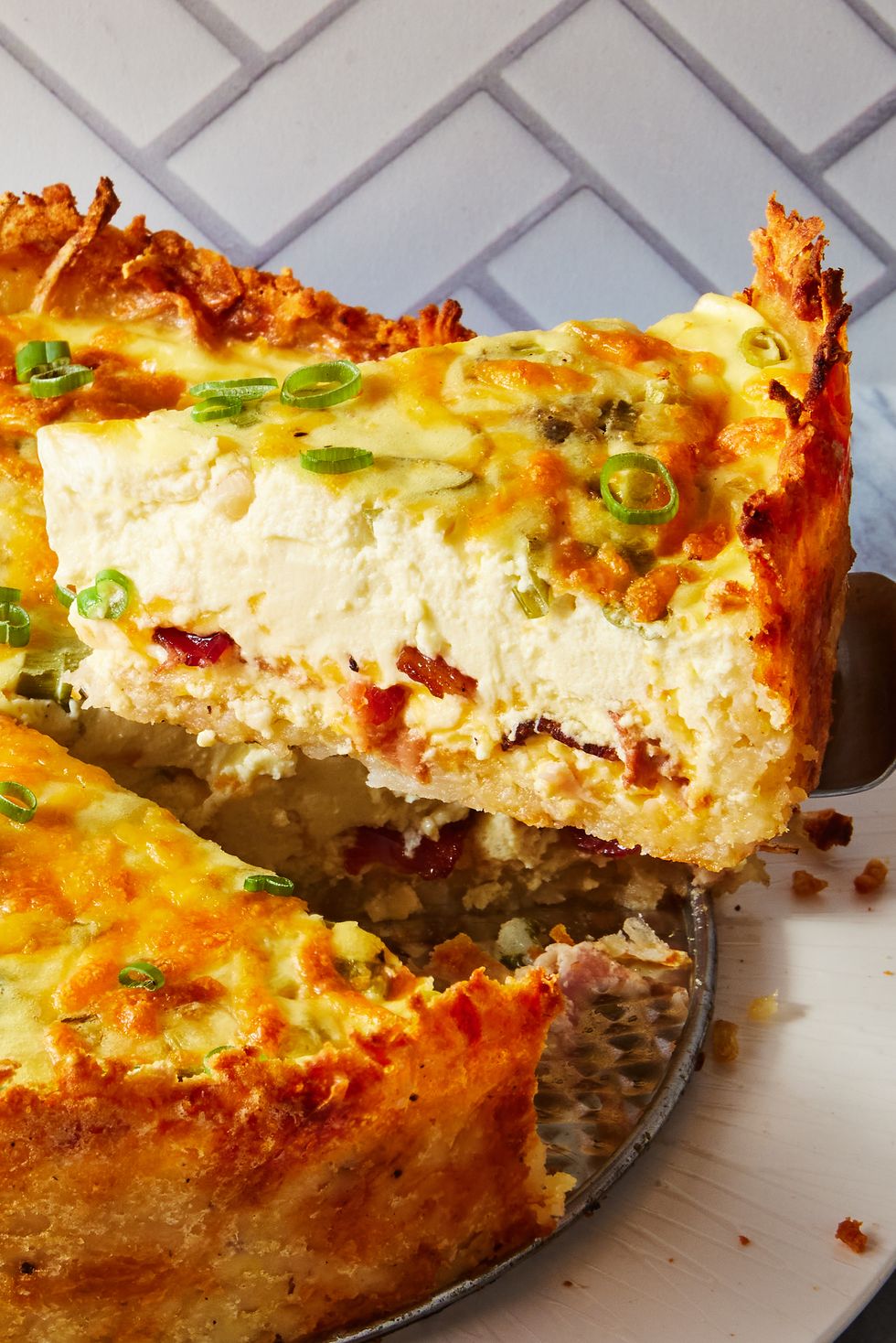 crispy hash brown crusted bacon cheddar quiche sprinkled with chives