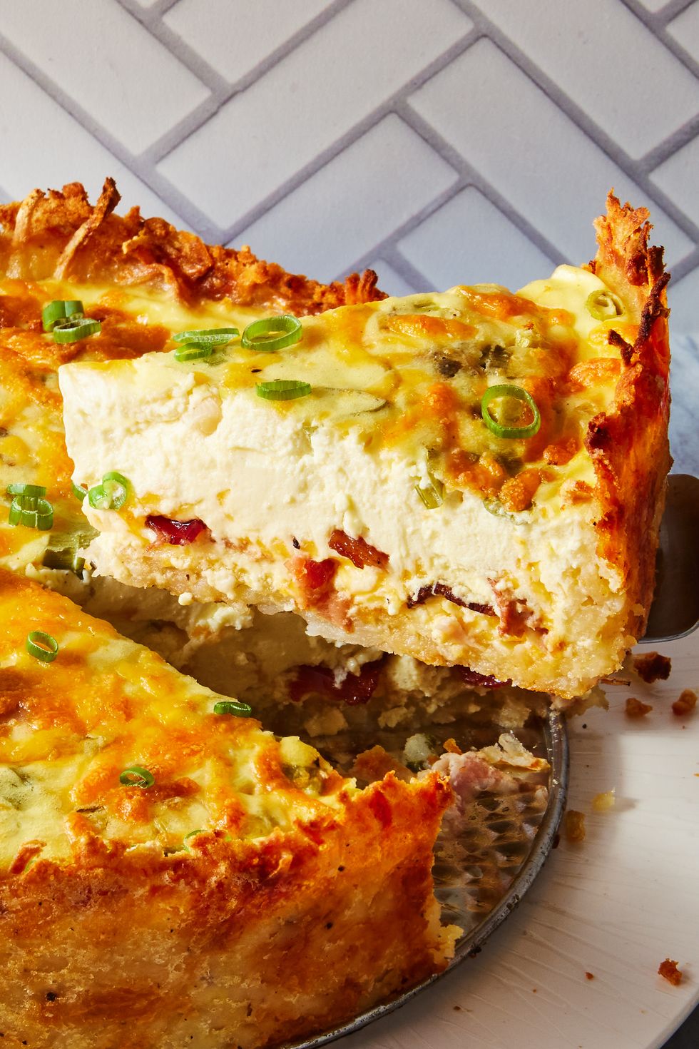 crispy hash brown crusted bacon cheddar quiche sprinkled with chives