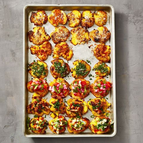 crispy roasted potatoes on a baking sheet with toppings
