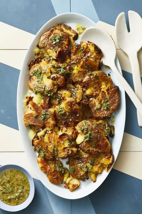 crispy smashed potatoes with caper gremolata on a white oval platter