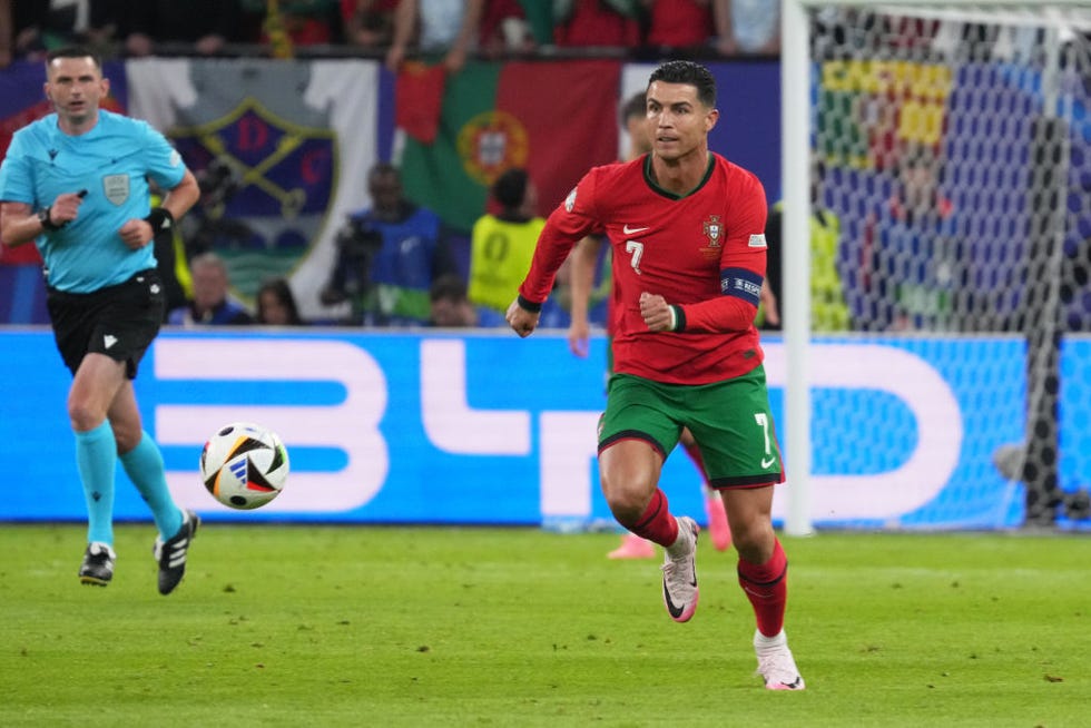 cristiano ronaldo at the uefa euro tournament dribbling a soccer ball upfield