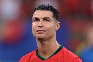 cristiano ronaldo looking up and smiling during a soccer game