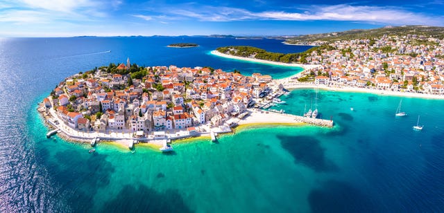 scenic town and beaches of primosten aerial panoramic view, turquoise archipelago and historic architecture of croatia