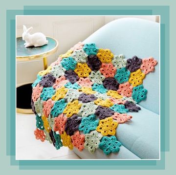 floral crochet blanket draped on a sofa