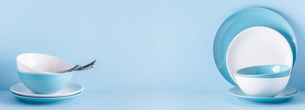 Crockery and cutlery on a blue pastel background