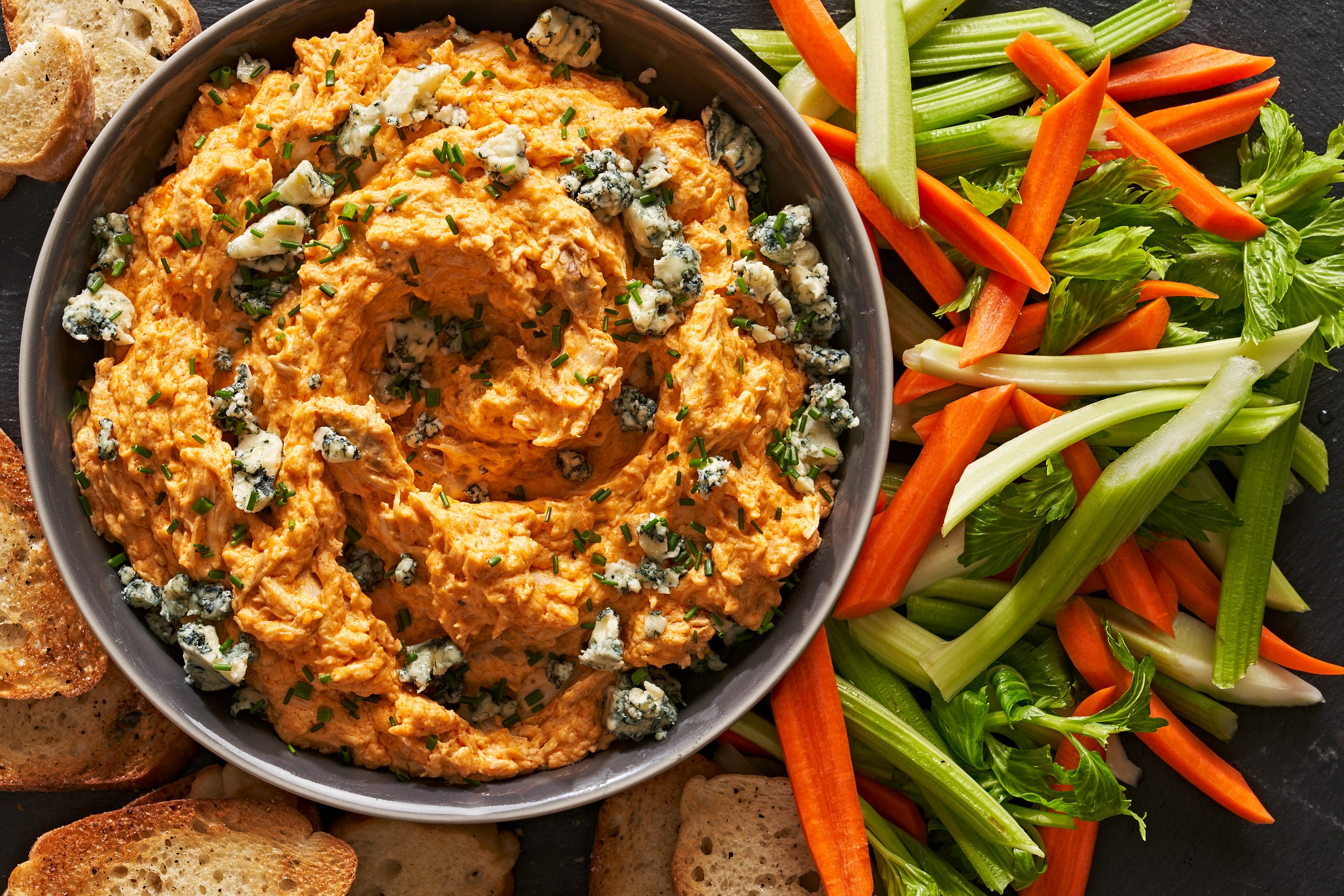 https://hips.hearstapps.com/hmg-prod/images/crockpot-buffalo-chicken-dip-1673025385.jpg?crop=0.883xw:0.745xh;0,0.0986xh