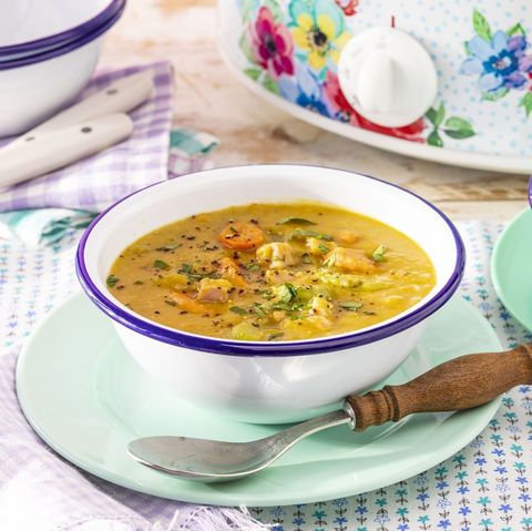 slow cooker split pea soup in white bowl with wooden spoon