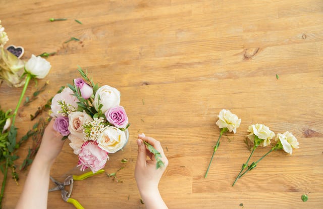 Crop hands of florist making bouquet