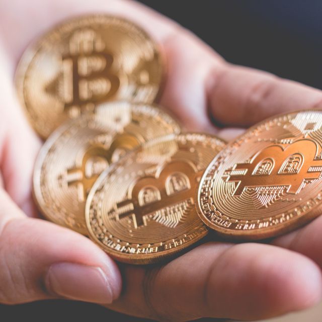 Cropped Hand Of Person Holding Bitcoins