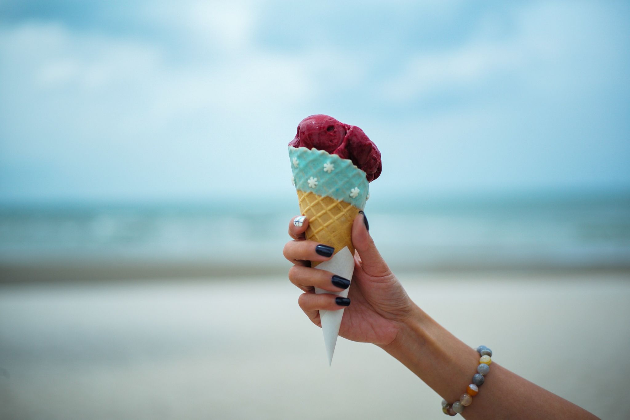 https://hips.hearstapps.com/hmg-prod/images/cropped-hand-of-woman-having-ice-cream-cone-at-royalty-free-image-1126904171-1562171131.jpg