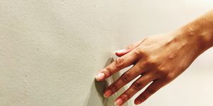 Cropped Hand Touching Wall
