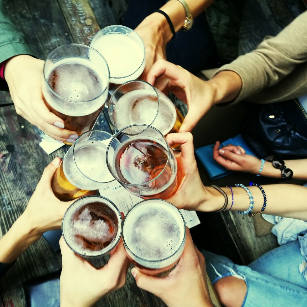 Cropped Hands Of Friends Toasting Alcoholic Drinks