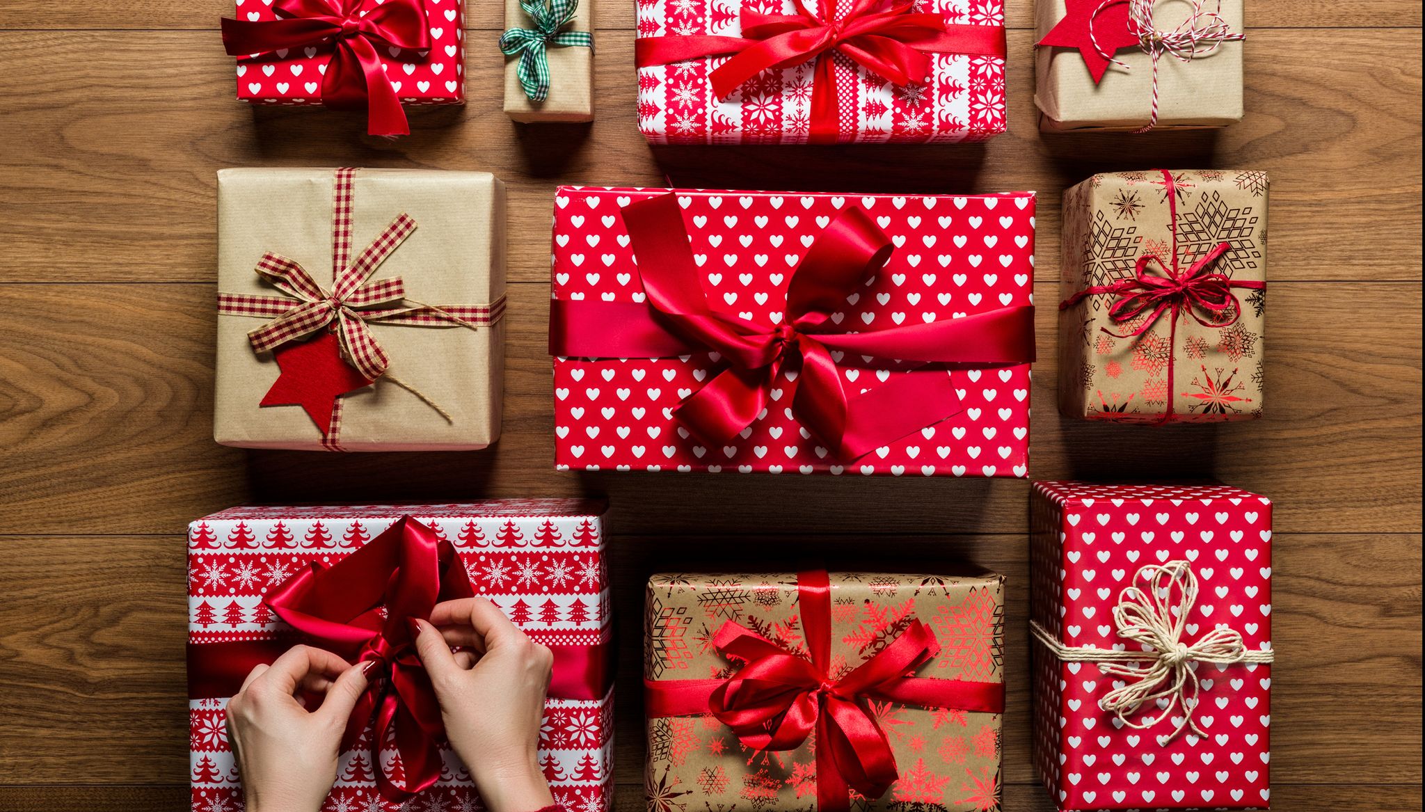 https://hips.hearstapps.com/hmg-prod/images/cropped-hands-of-woman-arranging-christmas-presents-royalty-free-image-889538316-1544619359.jpg?crop=1.00xw:0.855xh;0.00173xw,0.0805xh&resize=2048:*