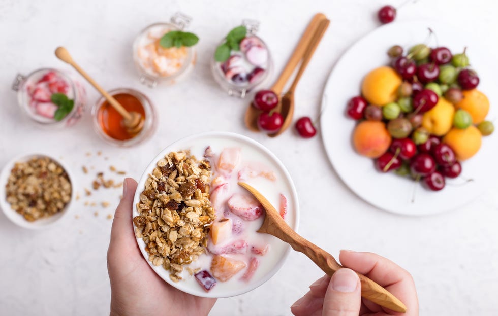 cropped hands of woman holding bowl of cereals