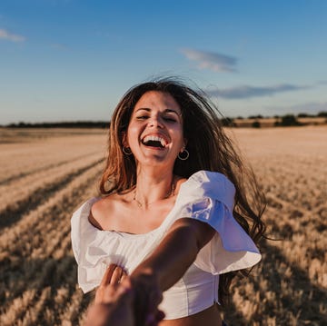 cropped image of boyfriend holding girlfriend hand on agricultural field