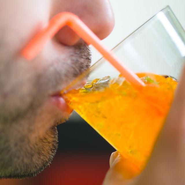 cropped image of man drinking juice from glass
