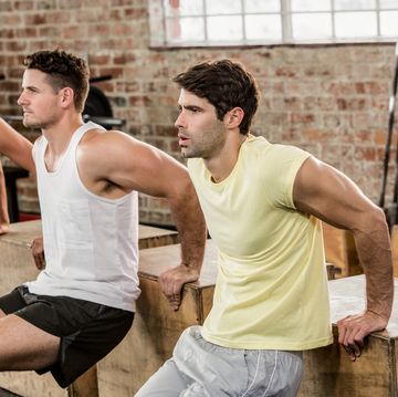 Cropped image of people holding plyo box and exercising