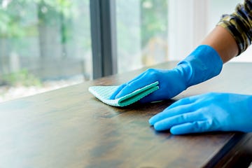 https://hips.hearstapps.com/hmg-prod/images/cropped-image-of-person-cleaning-table-at-home-royalty-free-image-1582709974.jpg?crop=0.674xw:1.00xh;0.287xw,0&resize=360:*