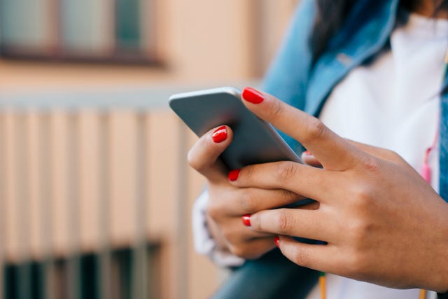 Cropped image of teenage girl using mobile phone