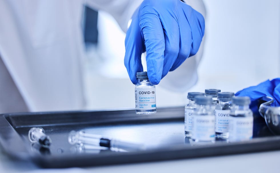 cropped shot of an unrecognizable scientist sorting out batches of the covid 19 vaccine on a tray in the lab