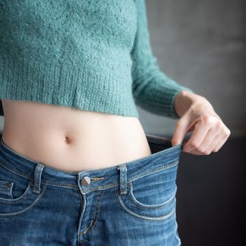 cropped shot of slim woman while wearing jeans