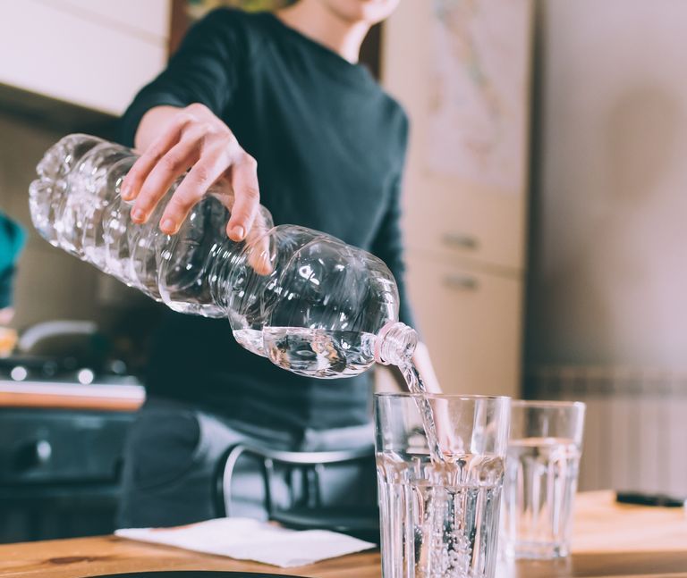 https://hips.hearstapps.com/hmg-prod/images/cropped-shot-of-young-woman-pouring-water-at-royalty-free-image-1582842706.jpg?crop=1xw:0.84296xh;center,top