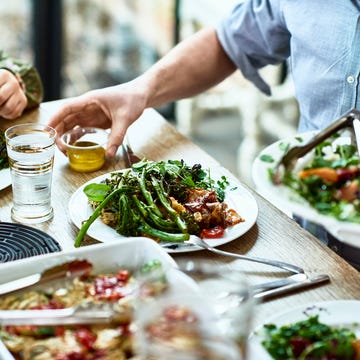 Cropped view of table laid with crockery and fresh homemade vegetarian food