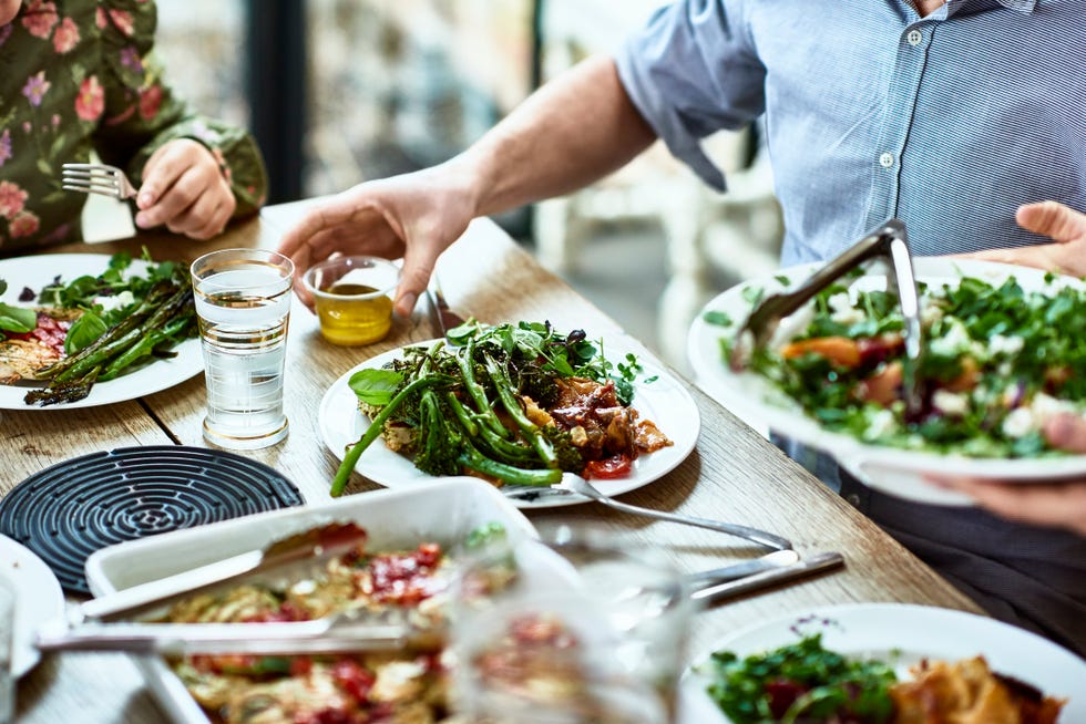 cropped view of table laid with crockery and fresh homemade vegetarian food