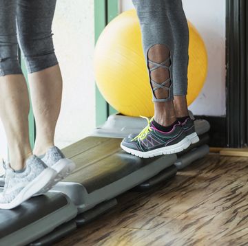cropped view of two women doing calf raises