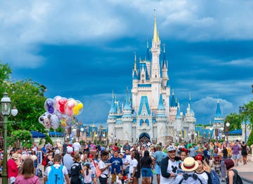 crowd of people at the cinderella castle in walt disney