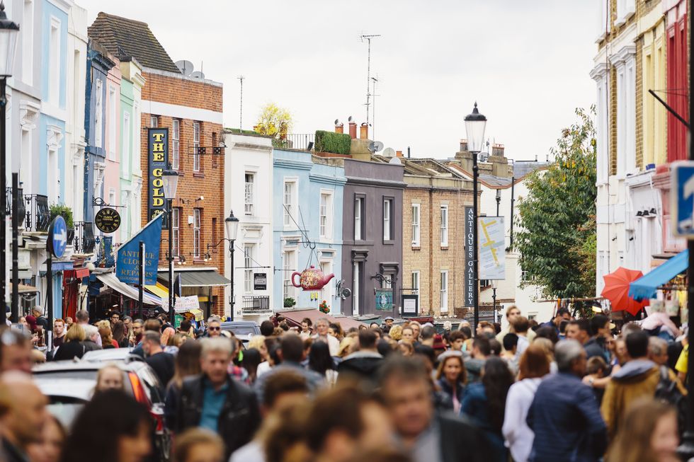 crowded street at portobello road market in notting hill, london, uk