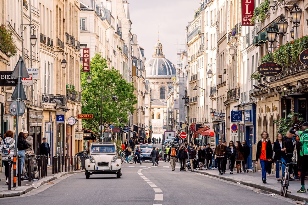 crowded street with cafes and restaurants in latin quarter on a sunny day, paris, france