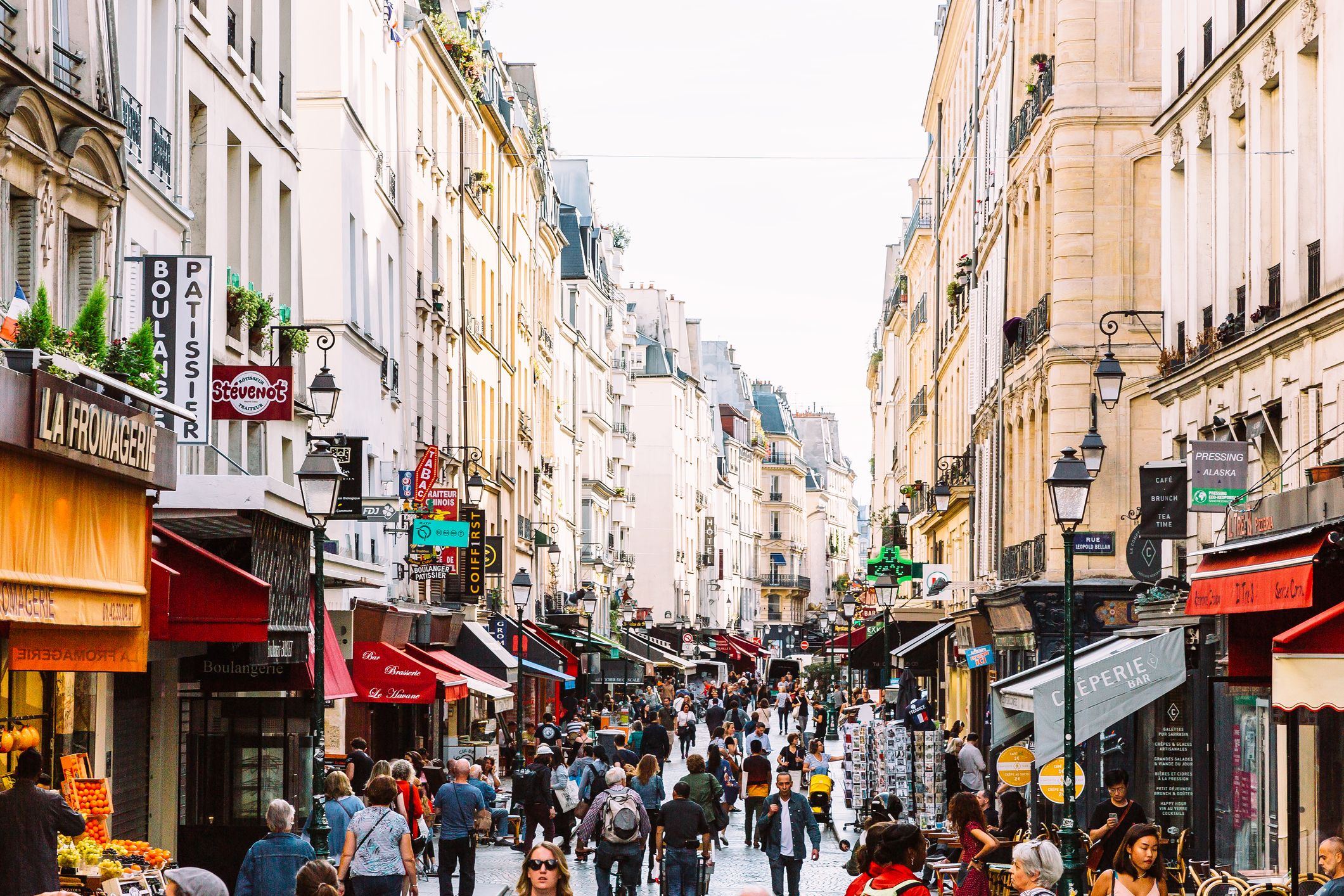 Crowds of people at Rue Montorgueil pedestrian street in Paris, France