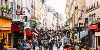 Crowds of people at Rue Montorgueil pedestrian street in Paris, France