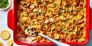 chicken casserole topped with ritz crackers in a red dish