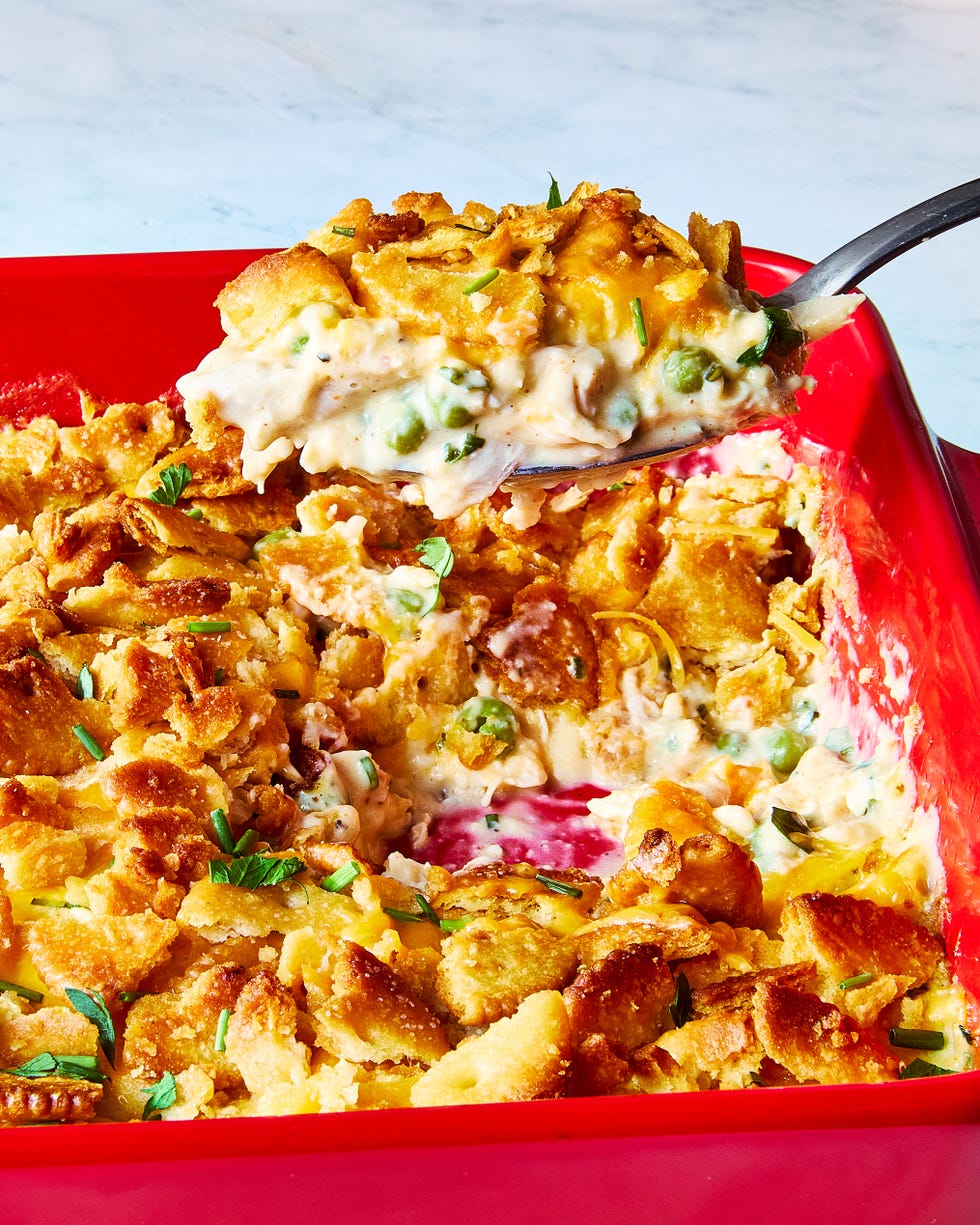 chicken casserole topped with ritz crackers in a red dish