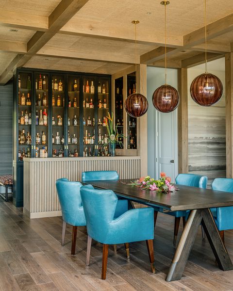 blue dining chairs with a bar and orb lighting