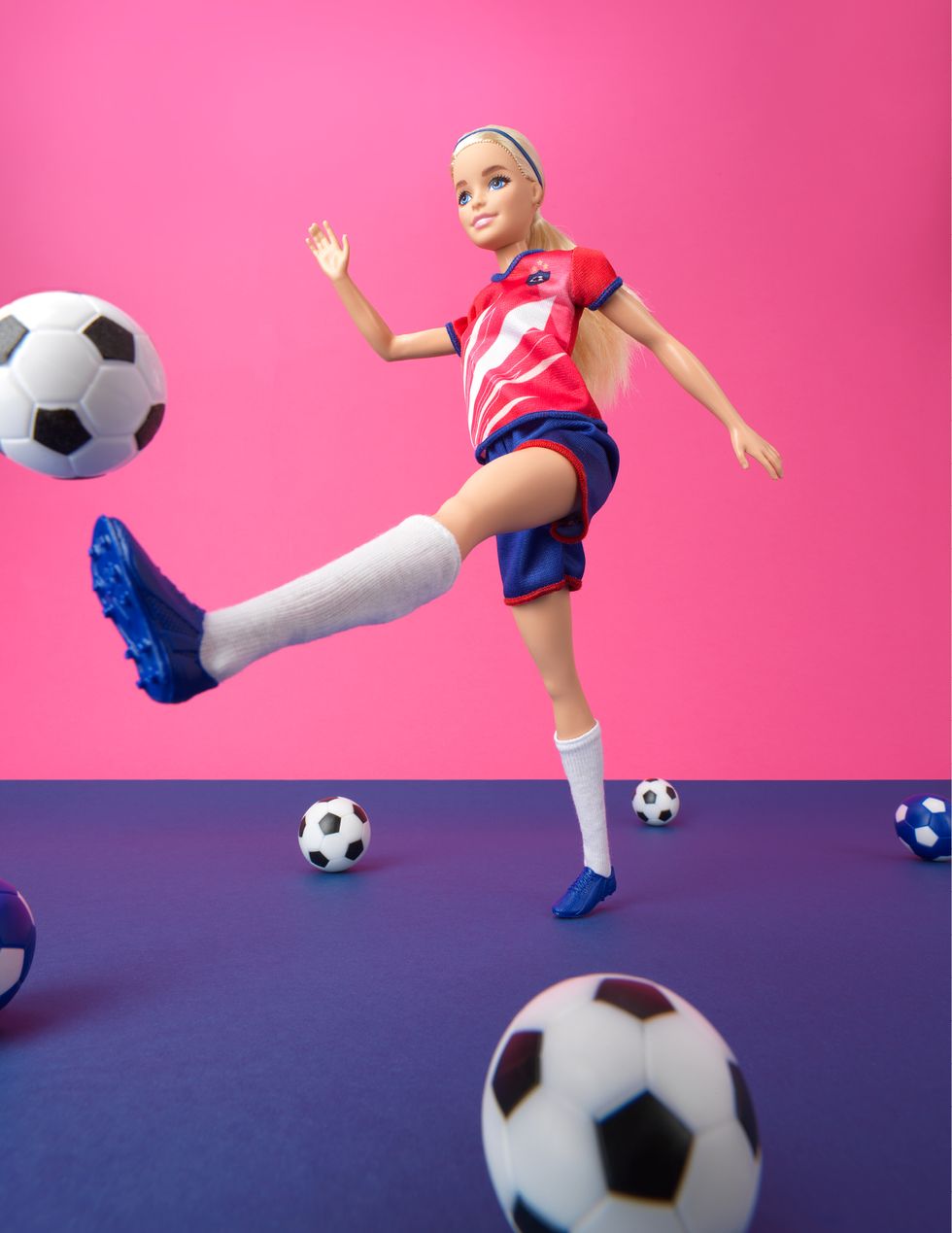 a girl kicking a football ball