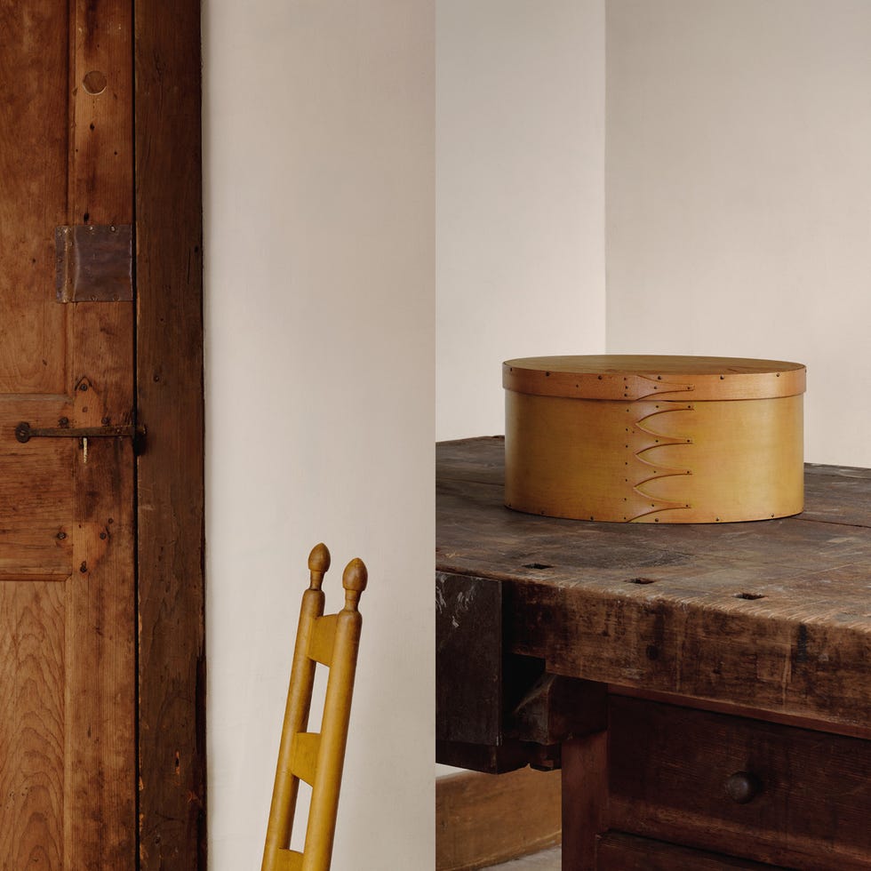 wooden chest on a rustic table next to a wooden door and a yellow chair