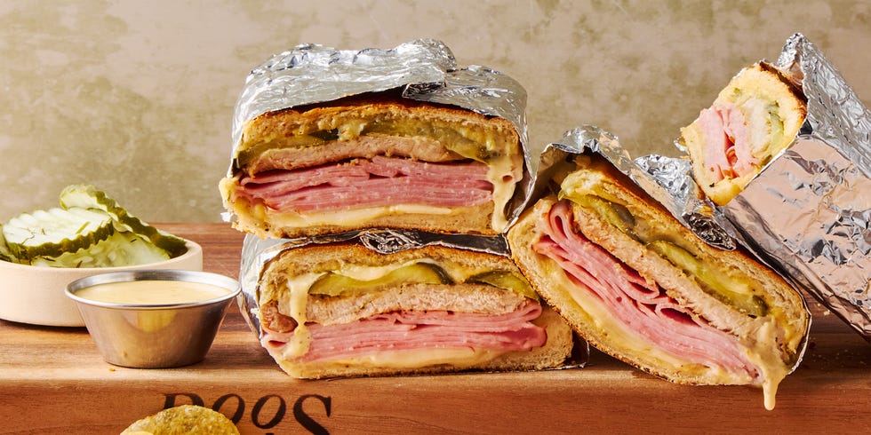 mojo marinated roast pork, thinly sliced deli ham, melty swiss cheese, and tangy dill pickles piled onto a cuban roll and griddled to golden brown perfection