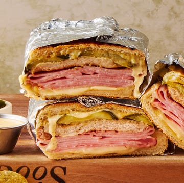 Cuban Sandwich mojo marinated roast pork, thinly sliced deli ham, melty swiss cheese, and tangy dill pickles piled onto a cuban roll and griddled to golden brown perfection