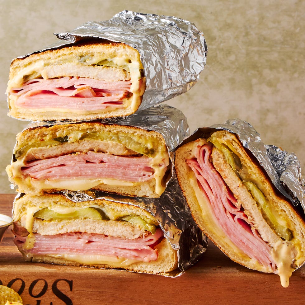 mojo marinated roast pork, thinly sliced deli ham, melty swiss cheese, and tangy dill pickles piled onto a cuban roll and griddled to golden brown perfection
